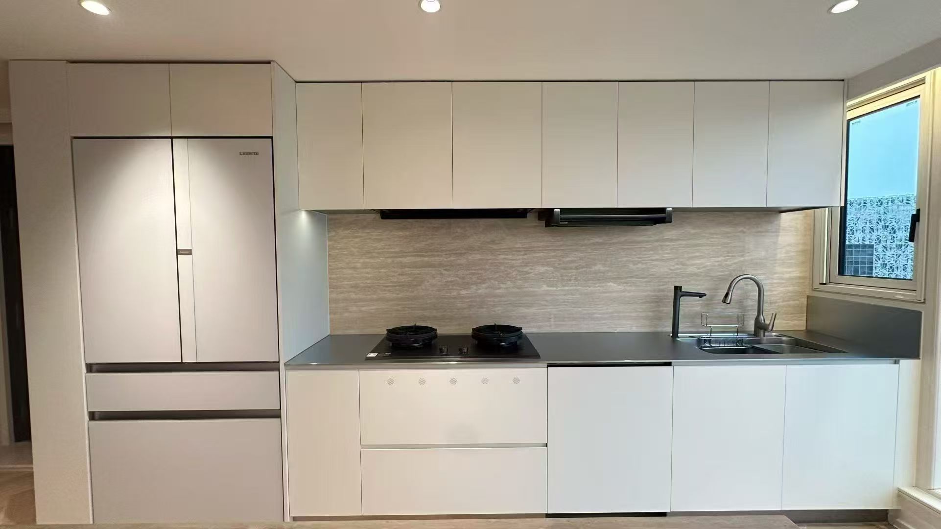Linear stainless-steel kitchen with integrated cabinetry